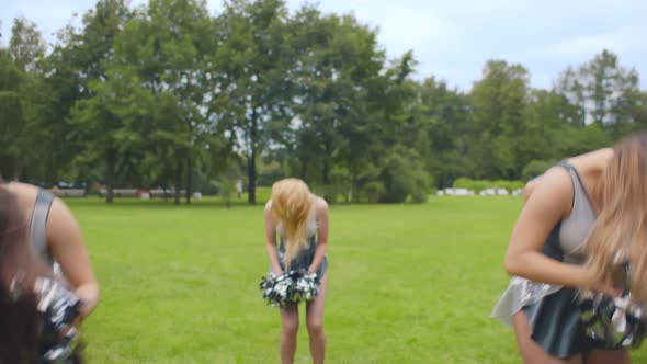 Attractive Young Cheerleaders Working Out in Summer Park