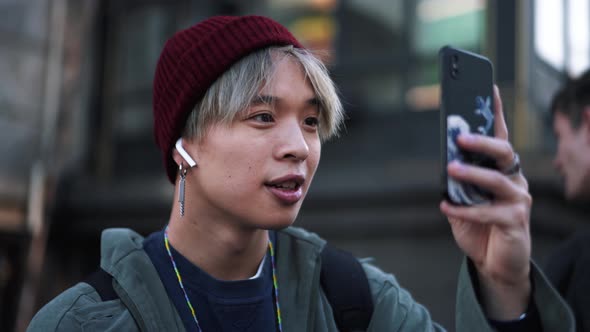 Handsome Asian man making video of the street