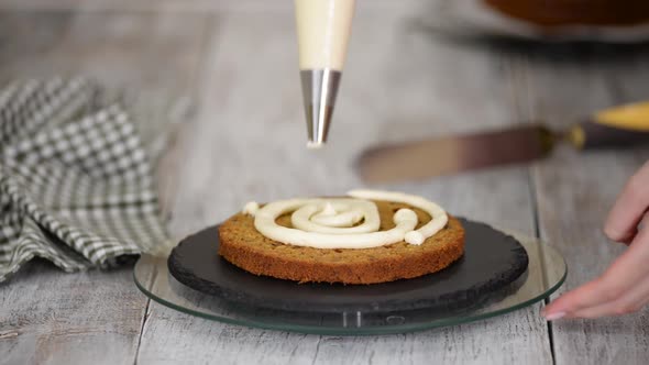 Pastry Chef's Hands Making Carrot Cake with Cream