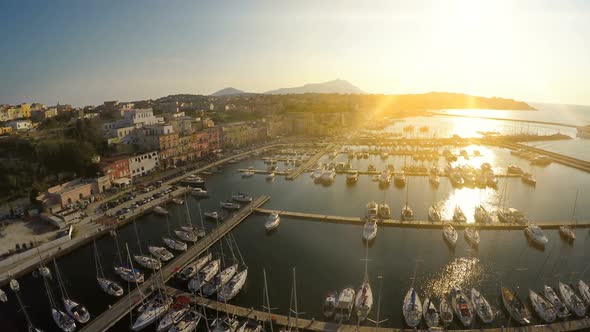 Sunrise Beams Penetrating Italian Town With Nice Architecture and Luxury Marina