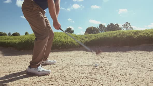 Man Hits Golf Ball From Sand Trap