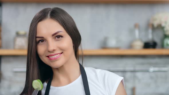 Closeup Portrait of Dancing Smiling Woman Holding Cucumber Using Fork Posing Looking at Camera