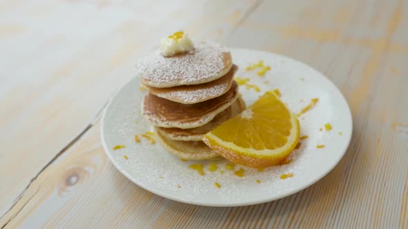 Fried Pancake with Orange on White Dish