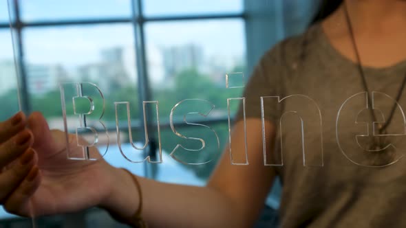 Woman Holding Glass Business Sign