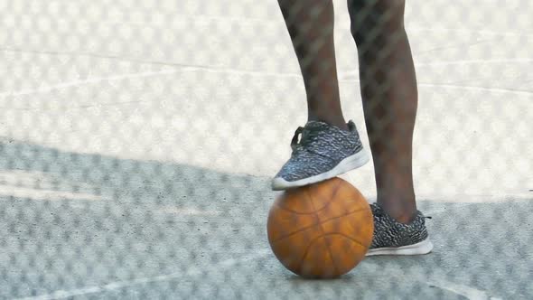 African American Guy in Sneakers Waiting for Team Gathering to Play Basketball