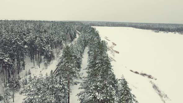 Beautiful Winter Landscape with Forest Lake and Road Aerial View