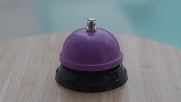 Close Up of Woman Hand Ringing the Bell and Calls a Waiter in Restaurant