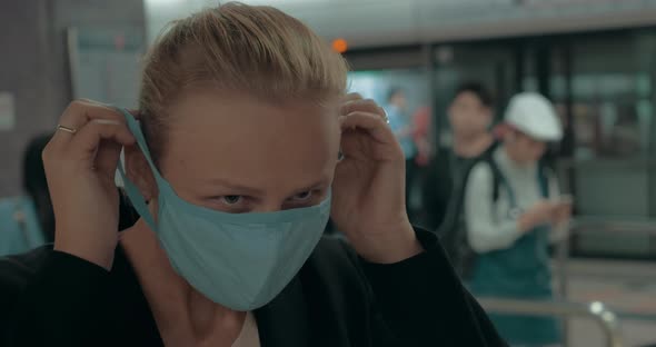 Young Blond Woman Wearing Surgical Mask in metro. Wuhan, China