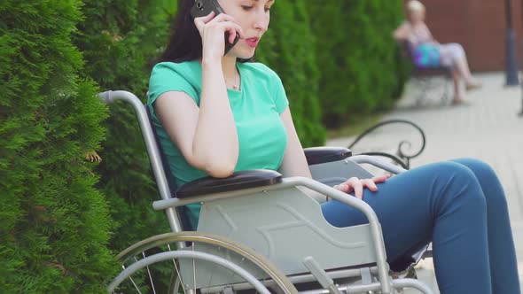 Attractive Girl in a Wheelchair Speaks on the Phoneslow Mo