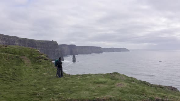 Aerial View of Beautiful Irish Cliffs Young Couple Watch the Landscape Panorama