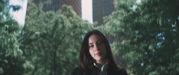 Woman stands infront of trees