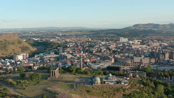 Circling drone shot of Calton hill Edinburgh at sunset