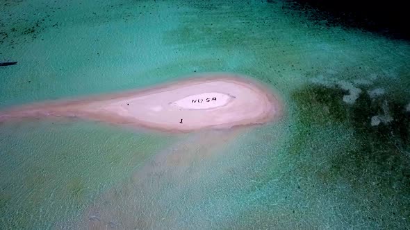 NUSA letters meaning island in Indonesian language formed by people on a tiny reef isle in Raja Ampa