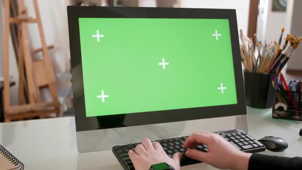 Male Hands Typing a Text on the Keyboard in Front of a Green Screen