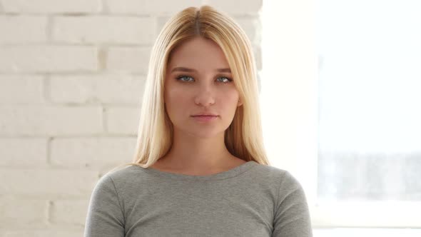 Woman Looking at Camera in Office