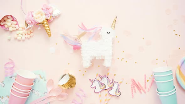 Birthday party in unicorn theme on pink flat lay.