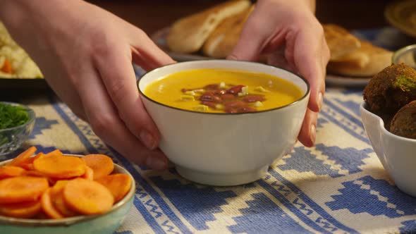 Putting Cooked Bean Soup on Table Closeup