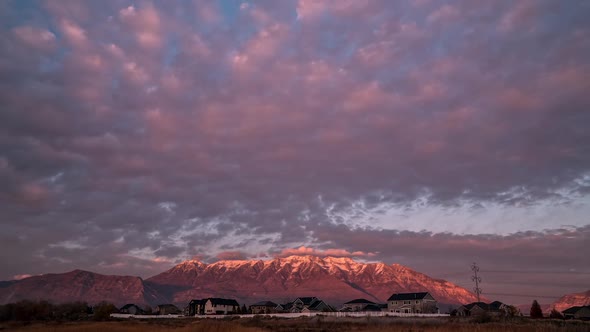 Colorful pink sunset over snow capped Timpanogos Mountain