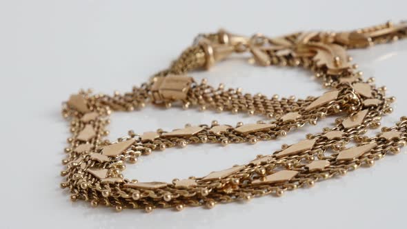 Detailed golden necklace chain slow pan 4K video