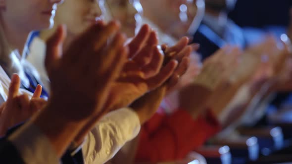 Business people applauding while sitting on seats in auditorium 4k