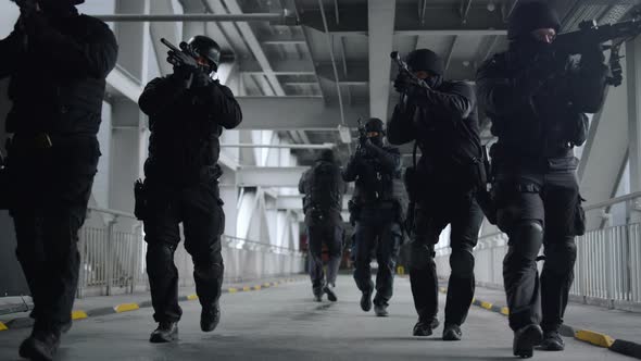 Front View Police Special Forces Walking on Metal Bridge of Urban Building