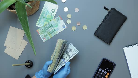 Counting money in protective gloves