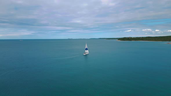 Sailing boat at Istria, Croatia. ship with a sail in the clear blue calm mediterranean seaside water