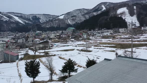 snow melting in nozawa onsen ski resort of nagano japan during winter, aerial