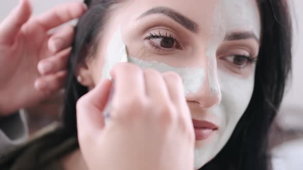 A Close-up of a Woman Having the Face Mask Applied on Her Face