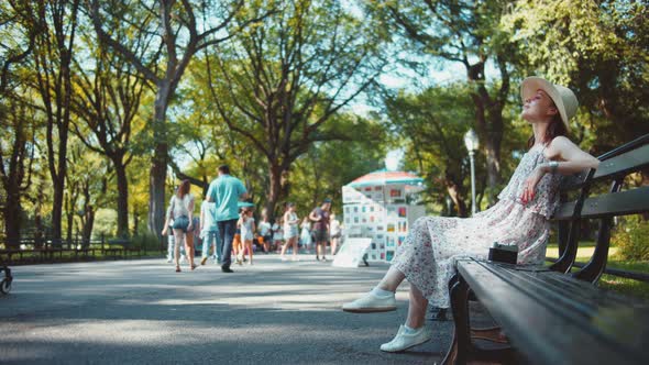 Young girl relaxing on a bench, NYC