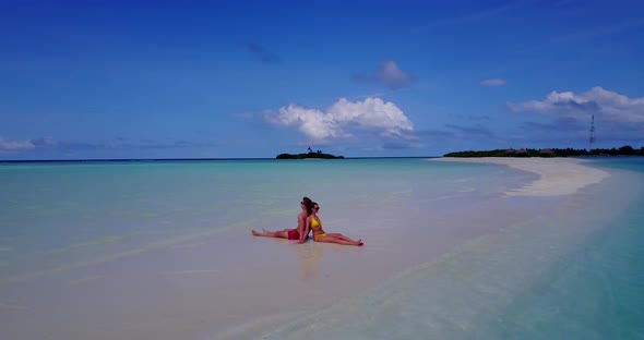 Beautiful couple on romantic honeymoon enjoy life on beach on sunny white sandy background