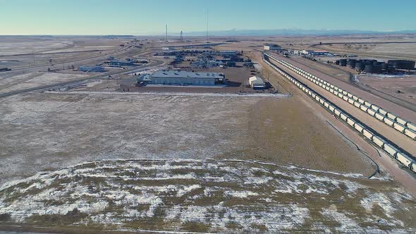 Descent up gimbal drone shot of an industrial park on winter morning.