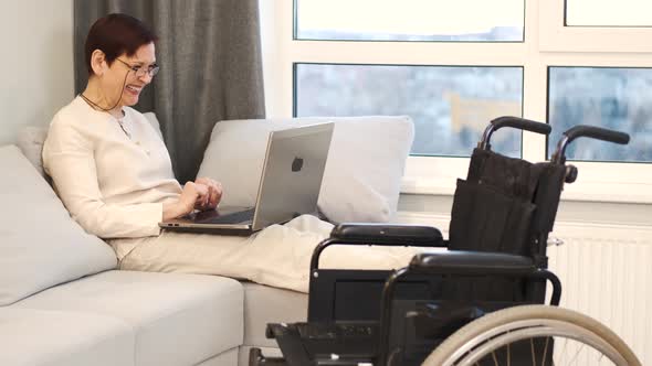 Handicapped Woman with Lapot Lay on Couch