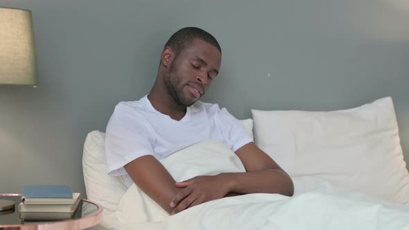 Sleepy Young African Man Taking Nap in Bed 