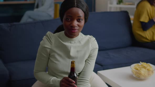 Closeup of Black Woman Portrait Looking Into Camera Drinking Beer for Friend Birthday