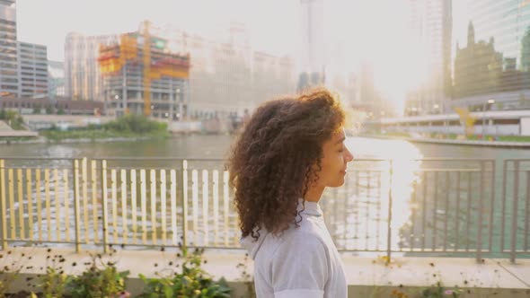 Cute African American woman walking along the River after her workout