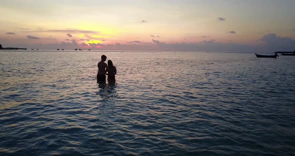 Fun lady and man on romantic honeymoon enjoy life on beach on summer white sandy background