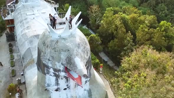 Tourists enjoys view from chicken style church building in Indonesia, aerial view