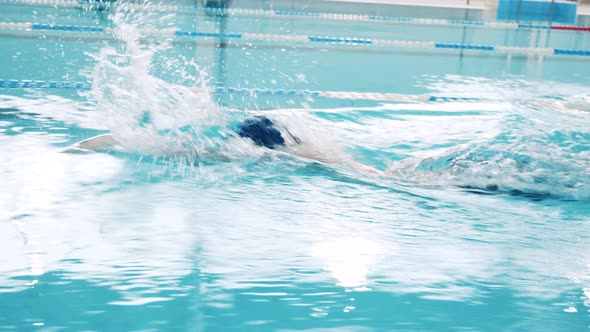 Close Up Shot of a Professional Male Swimmer in a Pool