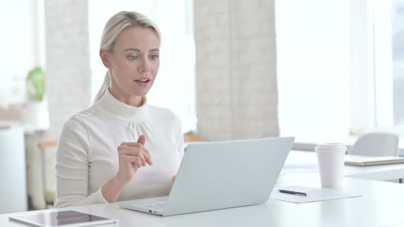 Young Businesswoman Doing Video Chat on Laptop