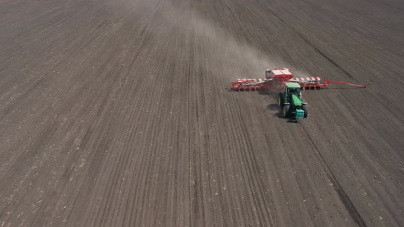 Working At The Field Tractor With The Seeder 17