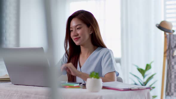 Portrait of beautiful business asian woman working online with laptop at home