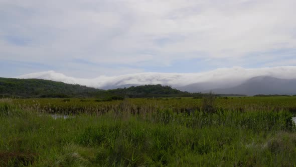 A landscape shot of clouds covering the mountains near Darby river in Wilsons Promontory National pa