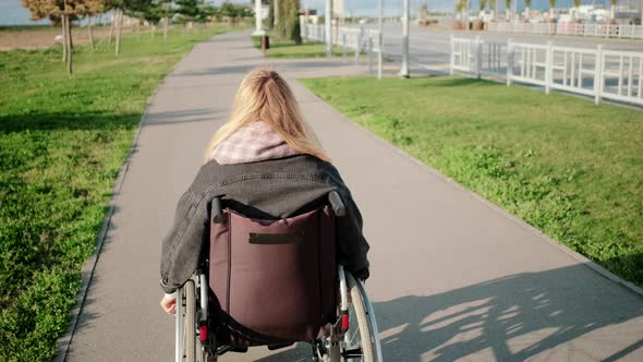 Woman in Wheelchair on Outdoor Walk