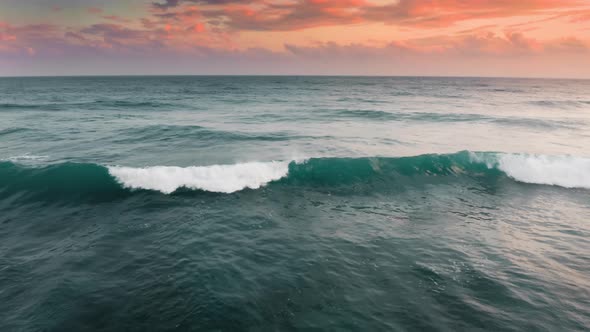 Aerial Footage of Beautiful Green Waves Breaking As They Roll to the Sea Shore