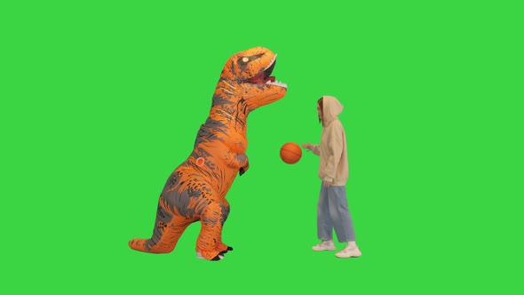 Girl Playing Basketball with a Man in Dino Costume on a Green Screen Chroma Key