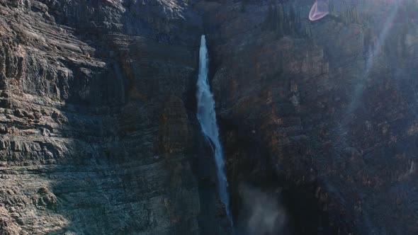 Large waterfall gushing with mist pulling out