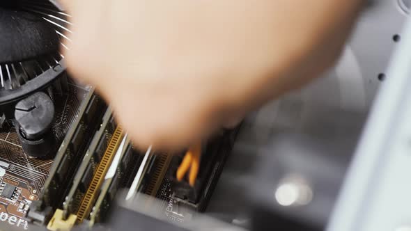 Close Up Man's Hand Connecting Main Wires From Desktop Computer Motherboard