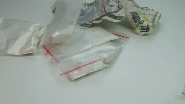 Cocaine and Crumpled Dollars Fall on the Table