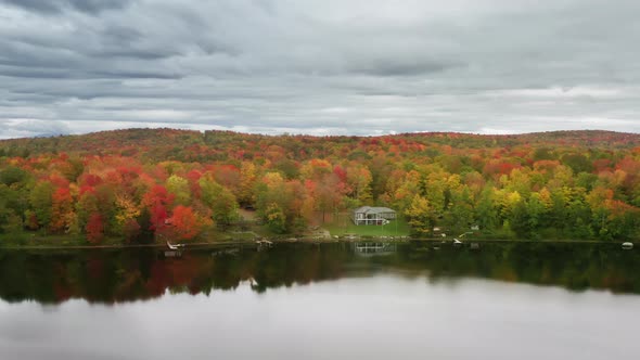 Cloudy Rainy Day at the Lake with Autumn Forest Golden and Orange Foliage